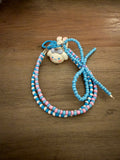 Handmade bag charm featuring a Cinnamoroll character charm on a beaded loop of blue, pink, and white seed beads.