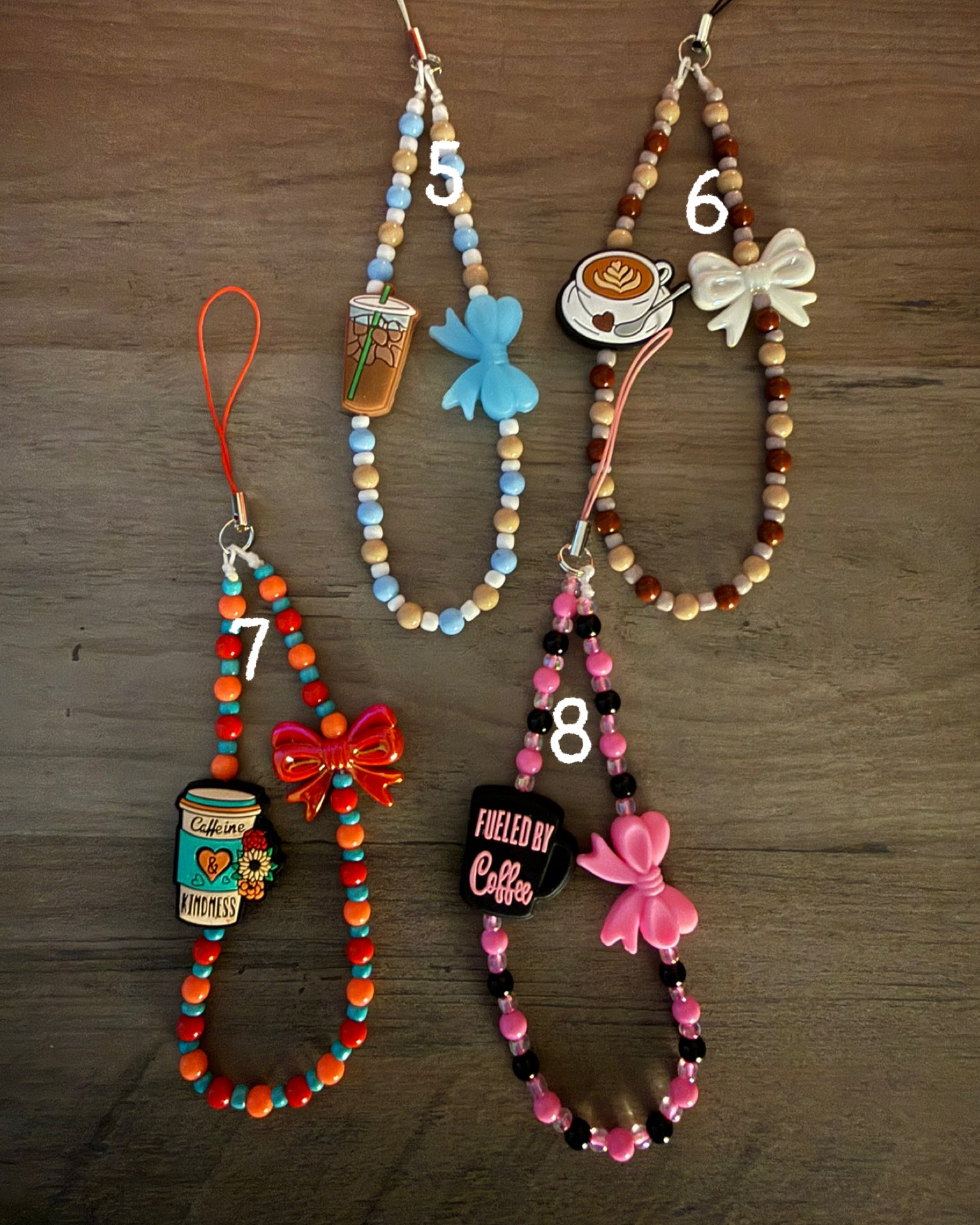 Four beaded wristlet charms featuring coffee-themed charms and bows in light blue, brown, orange, and pink color schemes.
