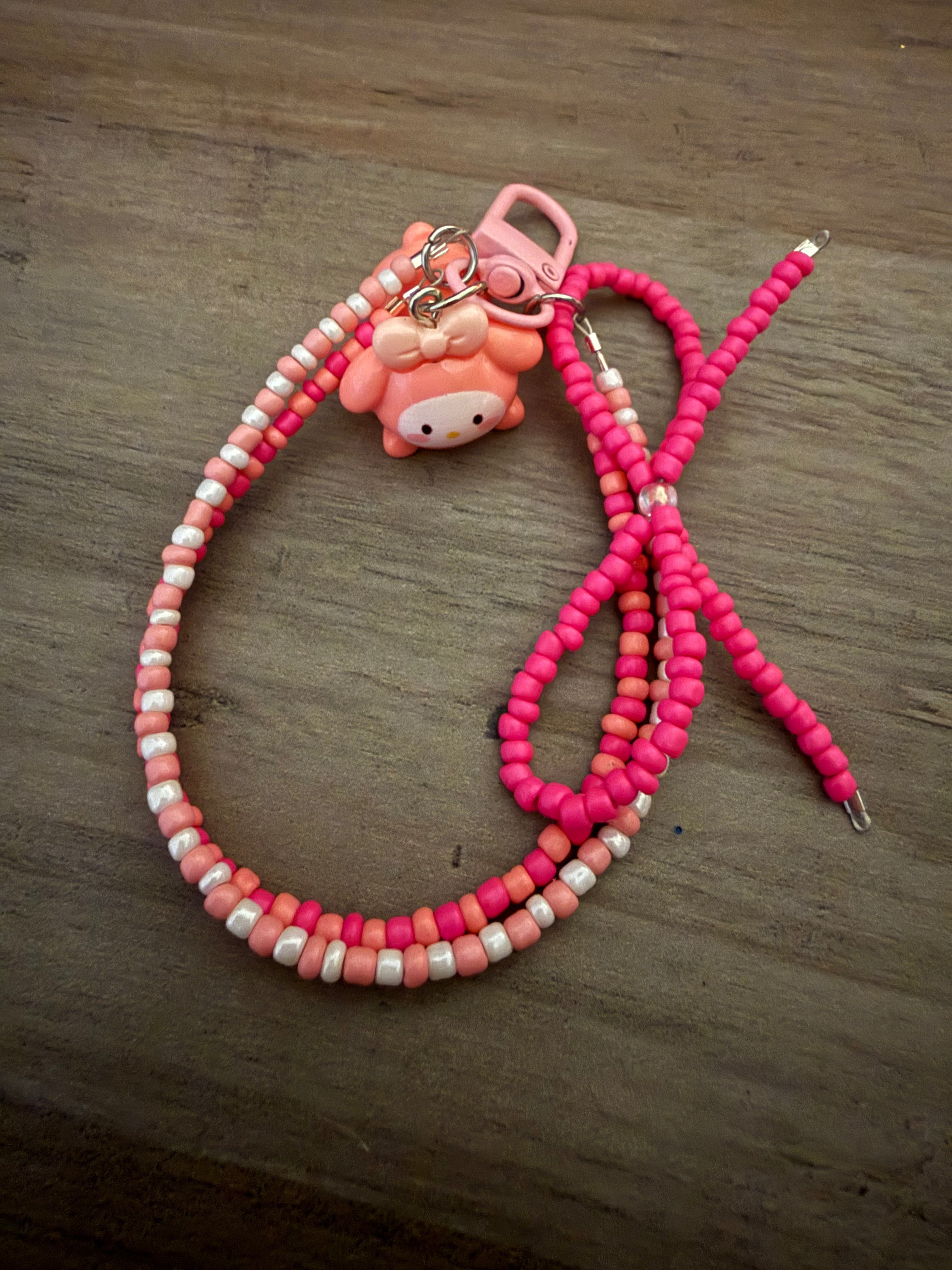 Handmade bag charm featuring a My Melody character charm on a beaded loop of pink, peach, and white seed beads.