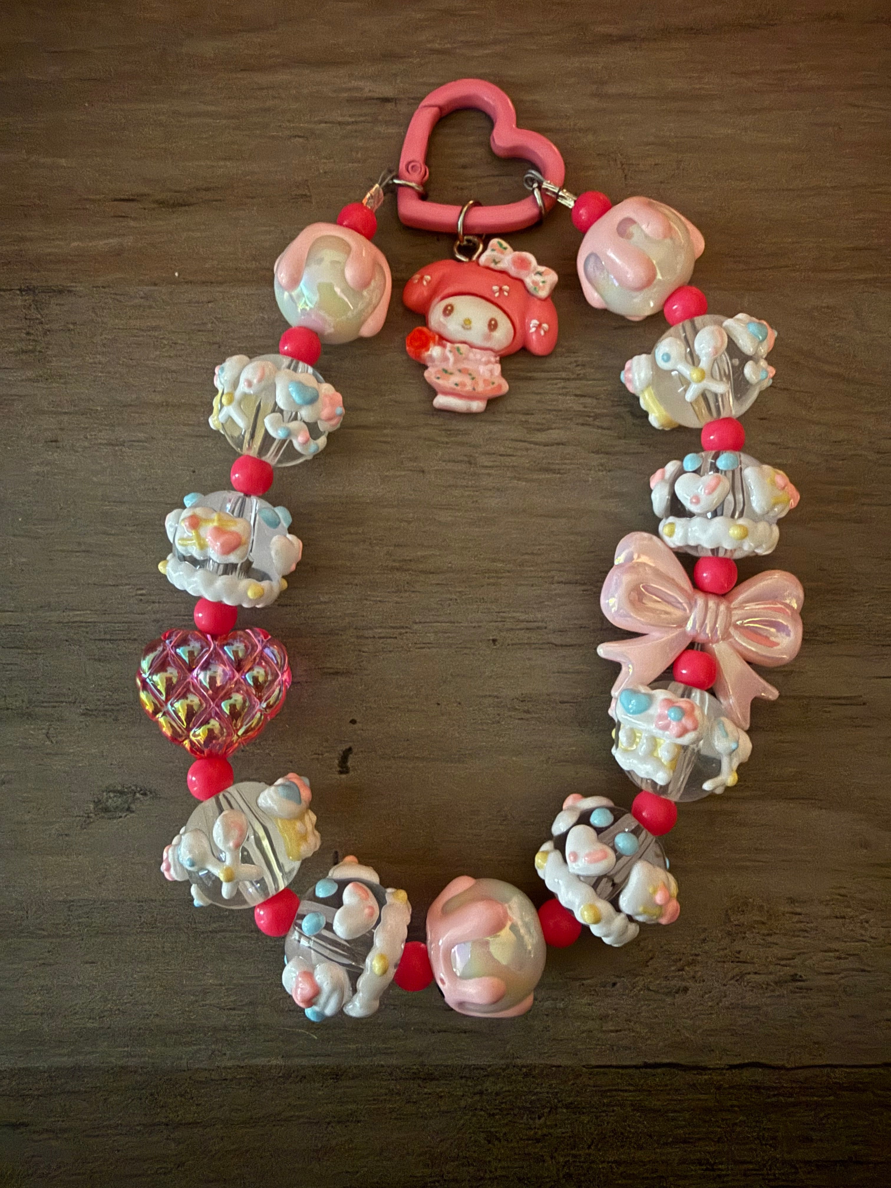 Colorful beaded keychain featuring a My Melody inspired charm, heart-shaped clasp, decorative beads with pastel colors, and a bow.