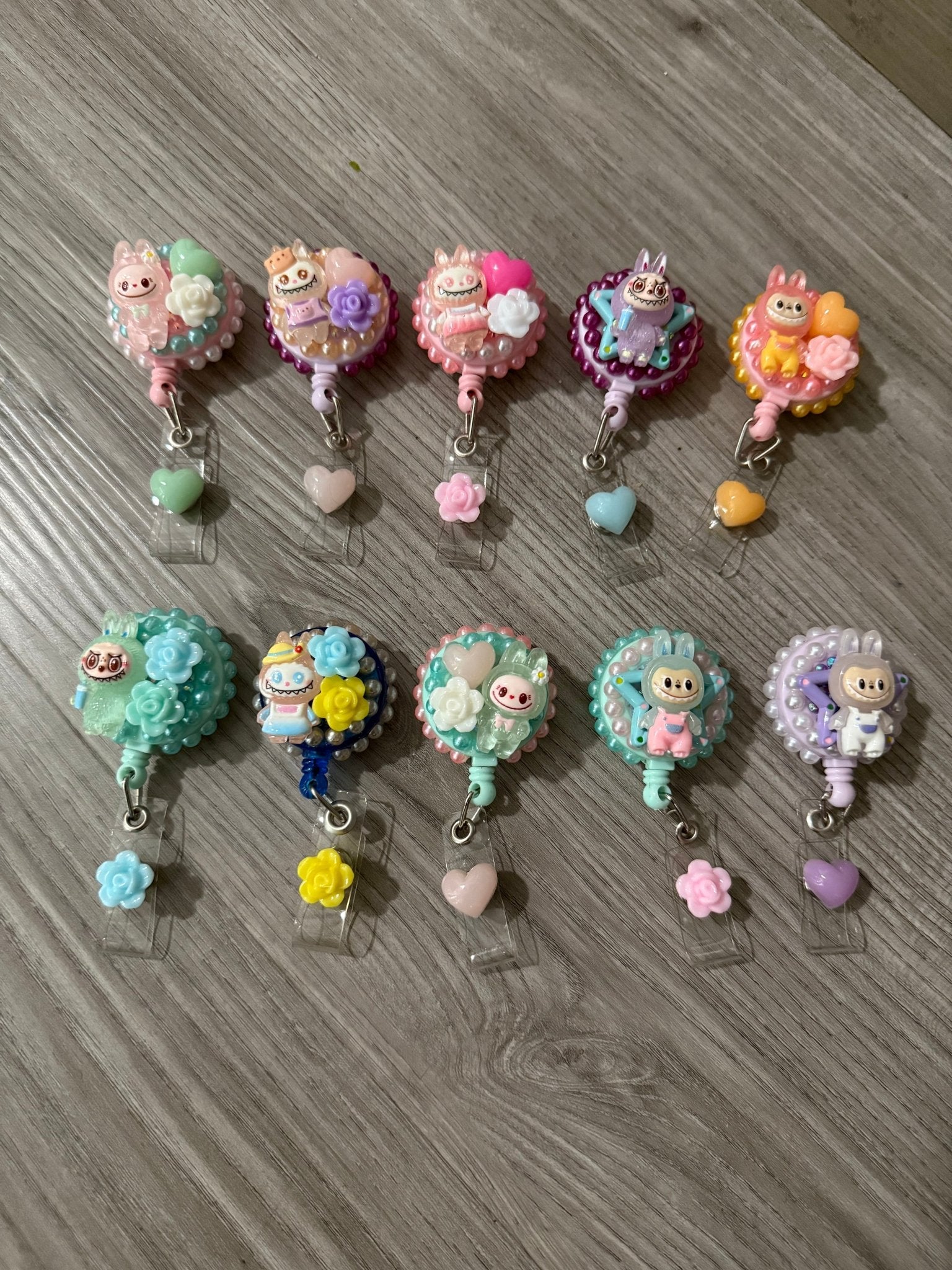 Ten decorative decoden badge reels featuring Labubu characters, colorful pearls, and resin charms.