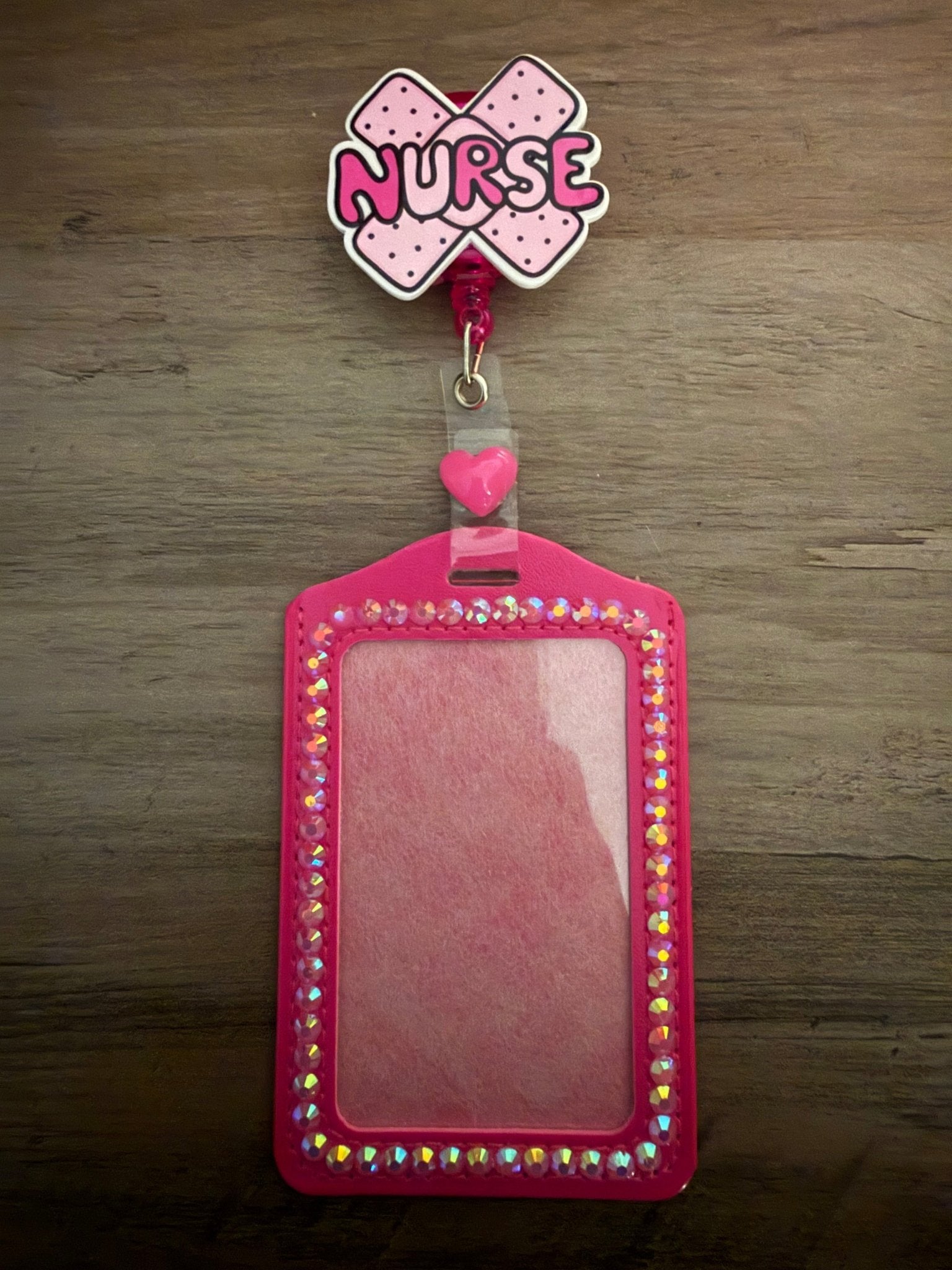 Handmade cross-bandage "Nurse" badge reel and hot pink ID holder lined with iridescent rhinestones and a heart.