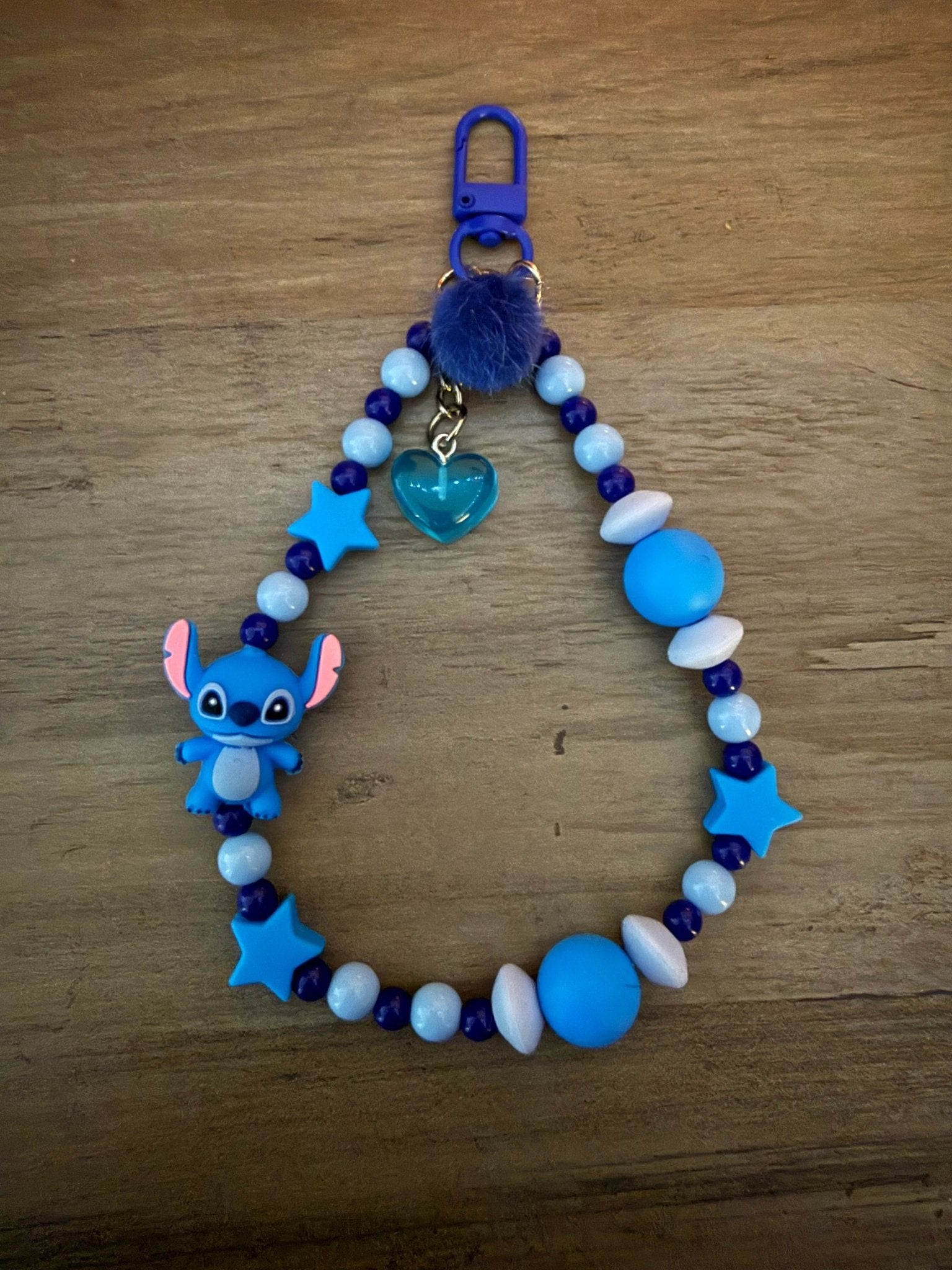 Blue bag charm/phone charm with character charm, star beads, heart charm, and blue pom-pom.