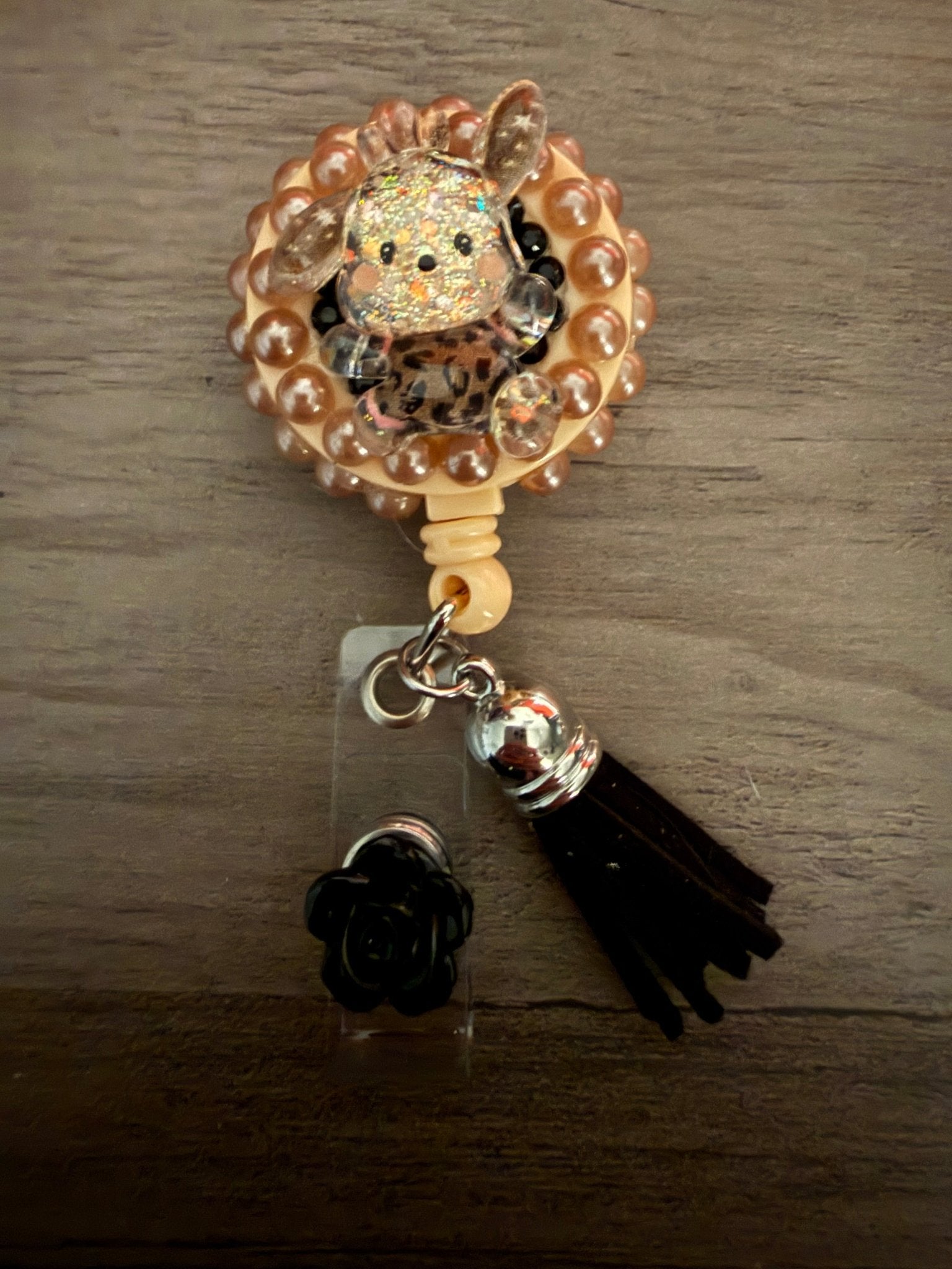 Handmade badge reel with a glittery Pochacco character, pearl border, and black tassel.
