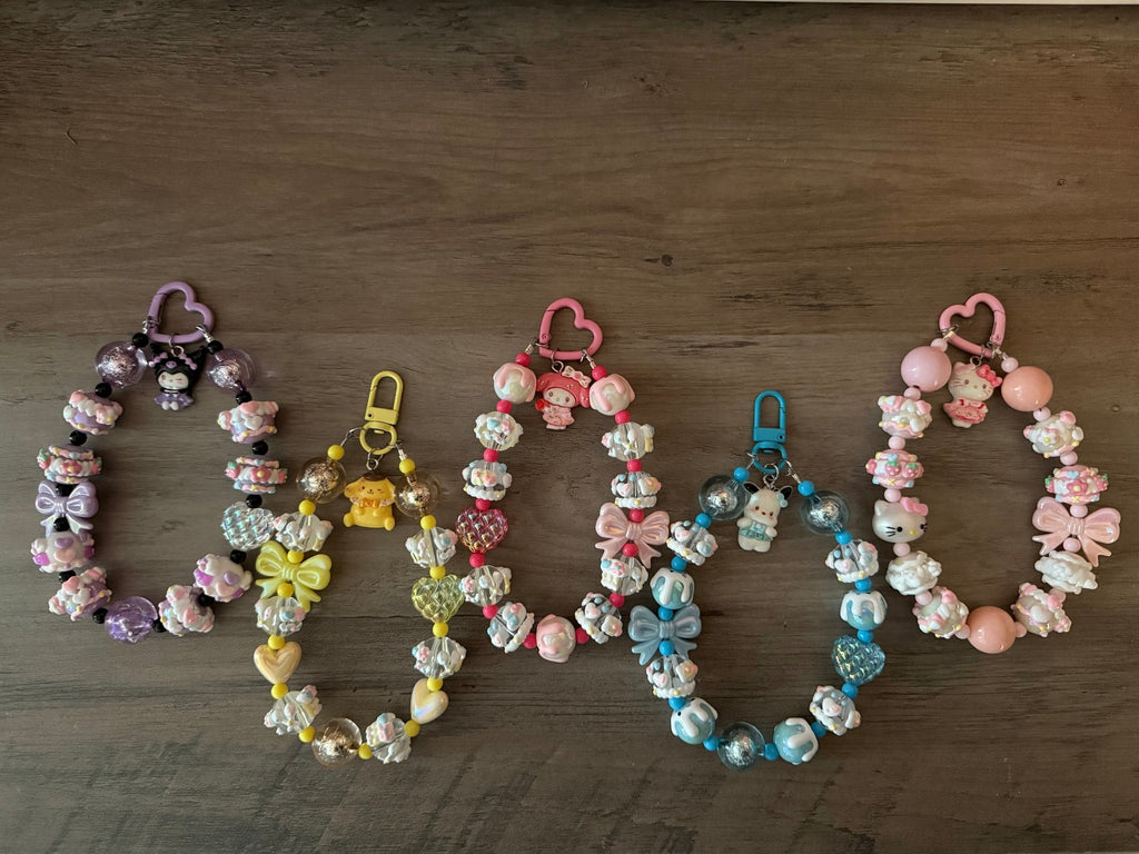 Five handmade Sanrio-themed beaded bag charms in assorted colors.