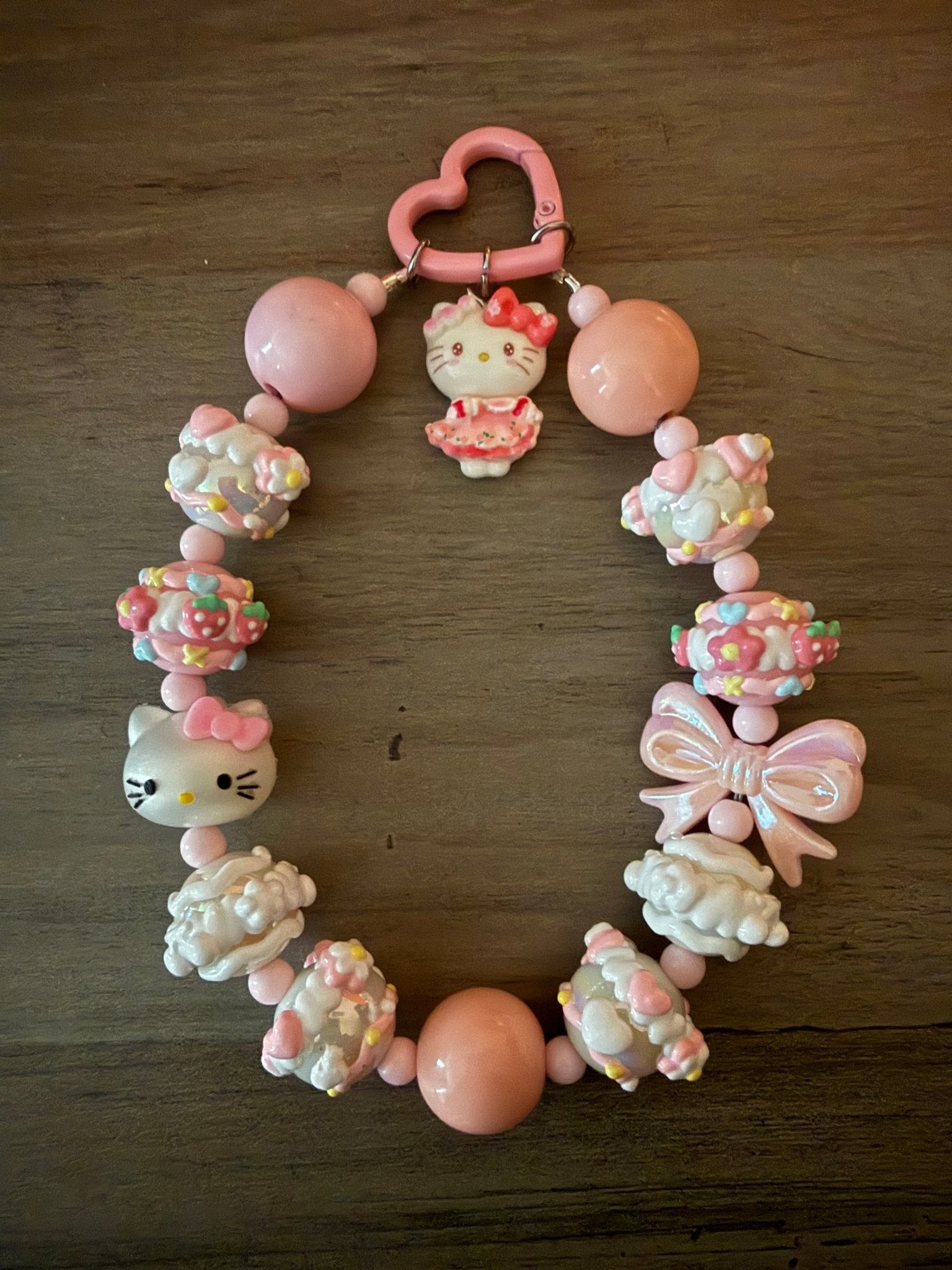 Handmade Hello Kitty beaded bag charm with pink and white accents and a pink heart clasp.