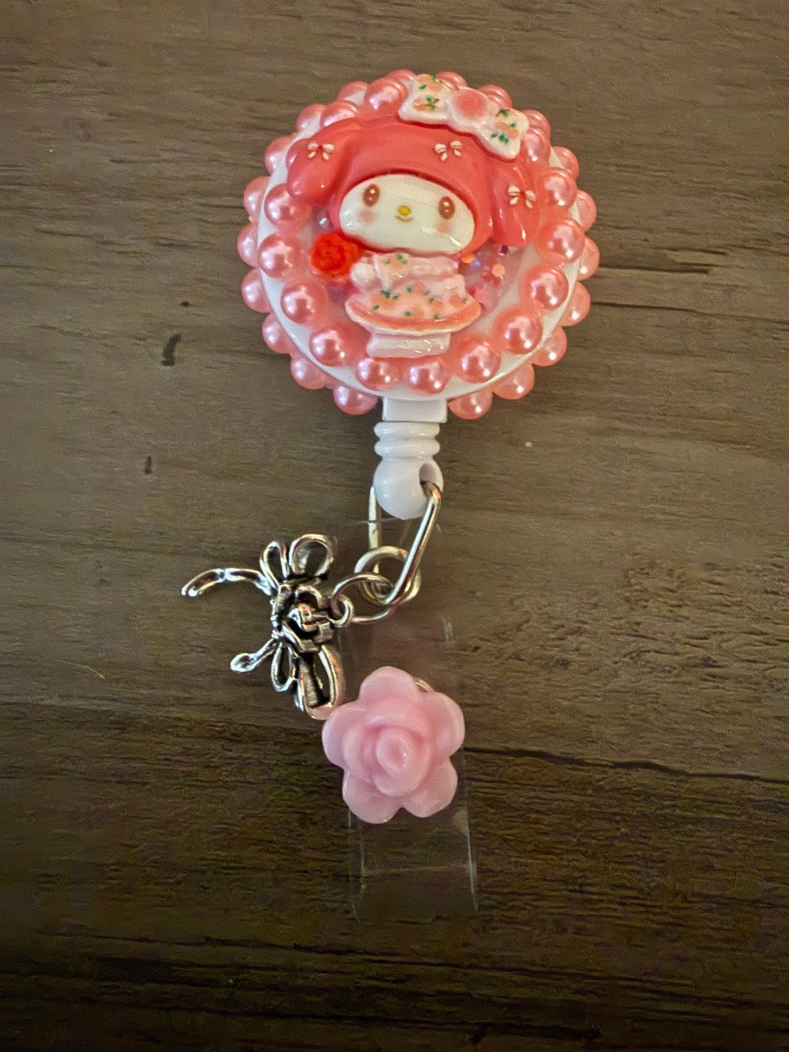 Handcrafted My Melody decoden badge reel with pink pearls, a silver bow, and a pink rose charm.