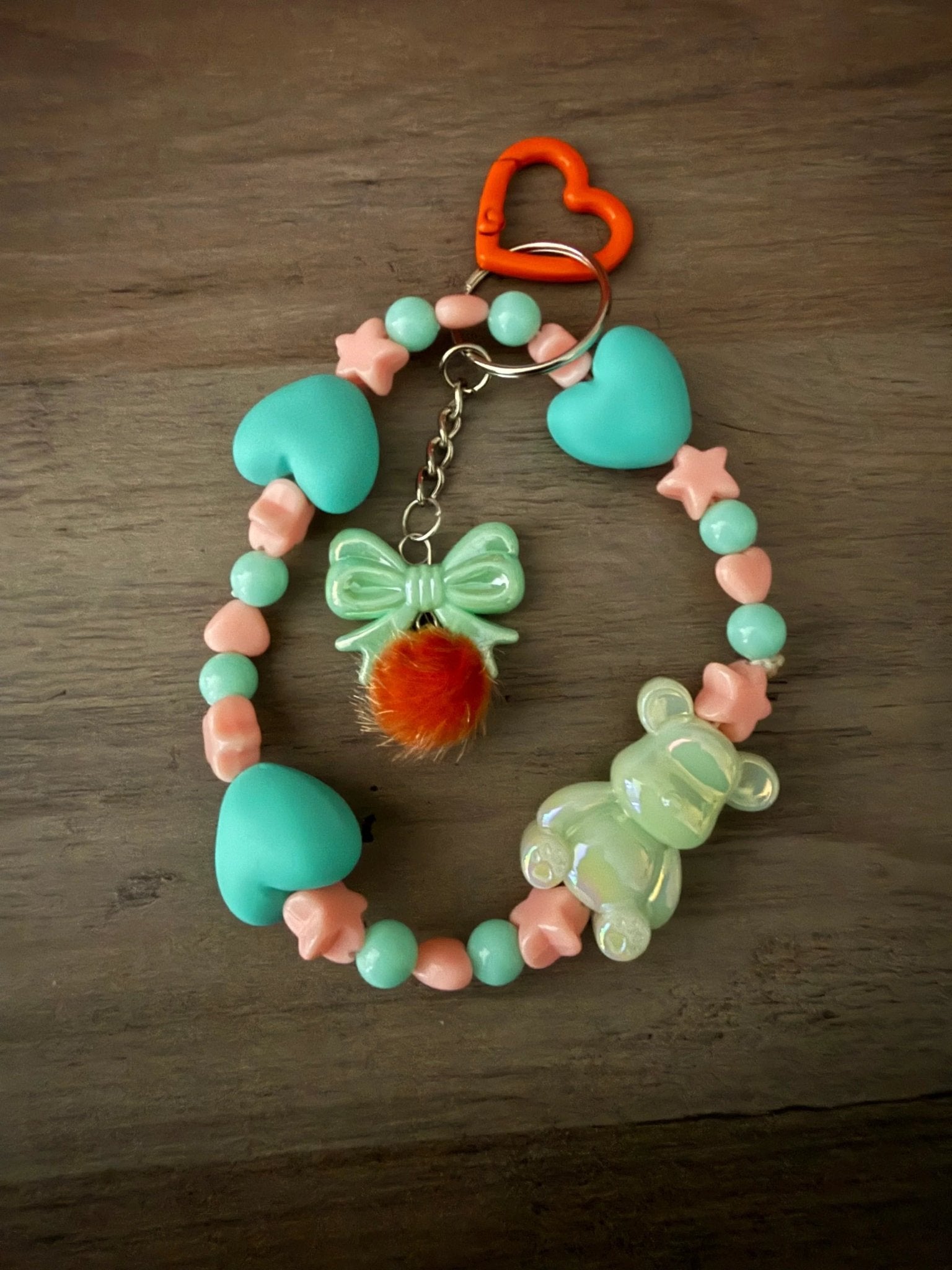 Colorful bag charms or phone charms with beads, bow, pom-pom, and bear charm.